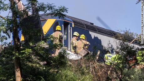 Emergency services respond to a derailed train Wednesday in Scotland.