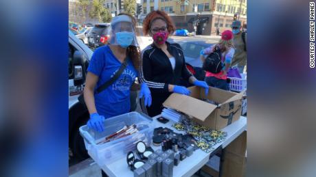 Volunteers Coco and Happiness handing out makeup to Skid Row&#39;s residents earlier this month. 