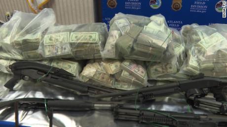 Money and firearms seized by the DEA.