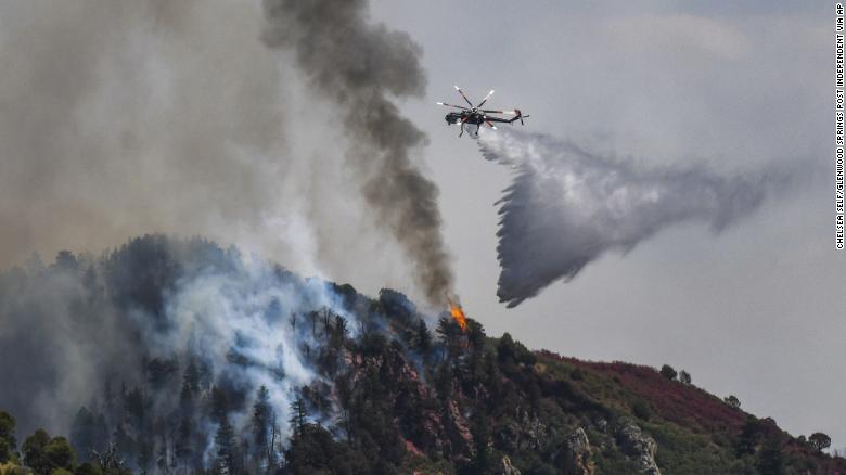 Fire crews work Tuesday to battle the Grizzly Creek Fire as it shoots down the ridge into No Name Canyon.