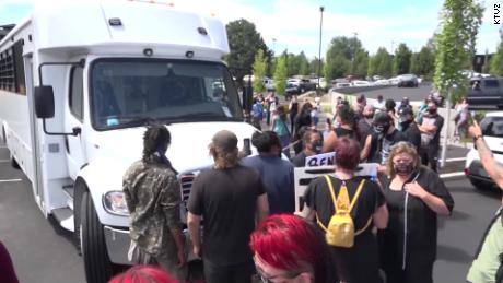 Protesters block one of two buses carrying ICE detainees Wednesday in Bend, Oregon.