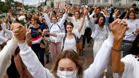 About 200 women march in solidarity with protesters injured in the latest rallies against the results of the country&#39;s presidential election in Minsk, Belarus, Wednesday, Aug. 12, 2020. Belarus officials say police detained over 1,000 people during the latest protests against the results of the country&#39;s presidential election.