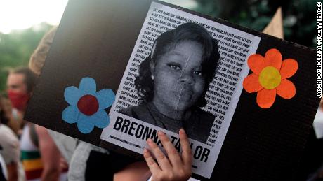 A demonstrator holds an image of Breonna Taylor during a protest in Denver last June. 