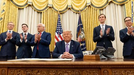 President Donald Trump, accompanied by from left, US special envoy for Iran Brian Hook, Assistant to the President Avraham Berkowitz, US Ambassador to Israel David Friedman, White House senior adviser Jared Kushner, and Treasury Secretary Steven Mnuchin, in the Oval Office on August 12.