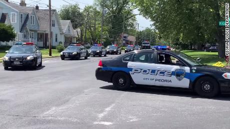 A line of Peoria police vehicles arriving at the lemonade stand when it reopened after the robbery.