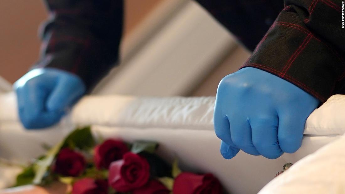 A family member looks into the casket of a loved one who died of Covid-19 in Denver in April. 