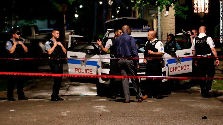 Police officers investigate the scene of a shooting in Chicago, Illinois, on July 21, 2020.