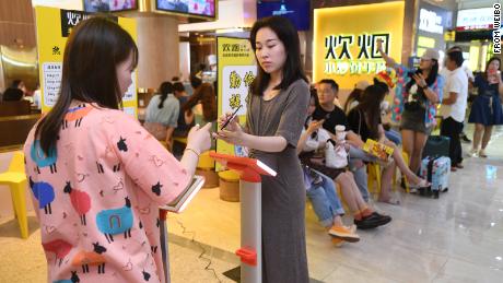Customers weigh themselves in the popular Hunan restaurant chain Chuiyan Fried Beef, in the city of Changsha. Signs around the restaurant say &quot;clean your plate&quot; and &quot;be thrifty and diligent.&quot;