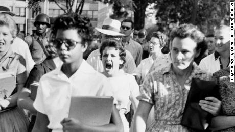 Elizabeth Eckford ignores the hostile screams and stares of fellow students on her first day of school. She was one of the nine negro students whose integration into Little Rock&#39;s Central High School was ordered by a Federal Court following legal action by NAACP.