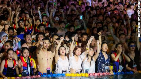 Partygoers stand shoulder to shoulder as they watch an eletronic music performance at the Wuhan Maya Beach Water Park.