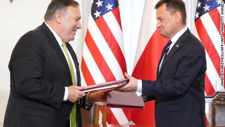 US Secretary of State Mike Pompeo and Polish Minister of Defense Mariusz Blaszczak exchange documents after signing the US-Poland Enhanced Defense Cooperation Agreement in the Presidential Palace in Warsaw, Poland, on August 15, 2020.