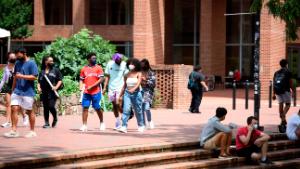 Students walk through the campus of the University of North Carolina at Chapel Hill on August 18, 2020 in Chapel Hill, North Carolina. The school halted in-person classes and reverted back to online courses after a rise in the number of COVID-19 cases over the past week. (Photo by Melissa Sue Gerrits/Getty Images)