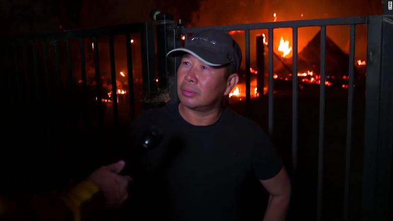 Thuy Ngo stands in front of his burning barn Wednesday near Vacaville.