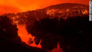 Embers burn along a hillside above Lake Berryessa as the LNU Lightning Complex fires tear through Napa County, California, on Tuesday, August 18. This image was taken with a long exposure.