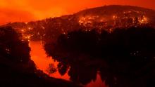 Embers burn along a hillside above Lake Berryessa as the LNU Lightning Complex fires tear through Napa County, California, on Tuesday, August 18. This image was taken with a long exposure.