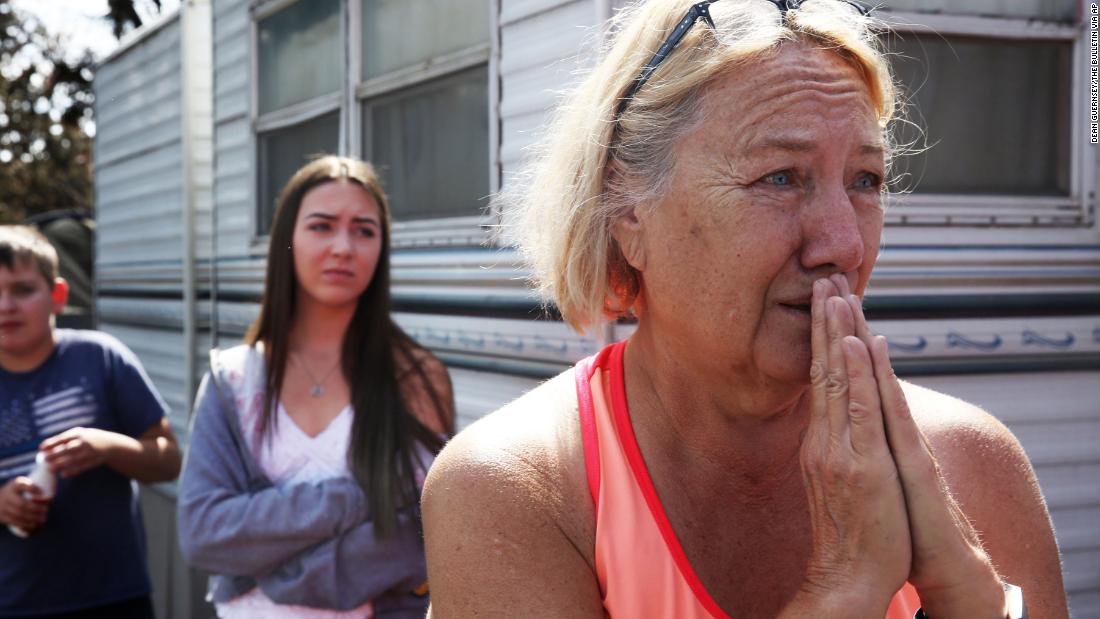 Kathy Mathison looks at the still-smoldering wildfire on August 16 that, just a day before, came within several feet of her home in Bend, Oregon.