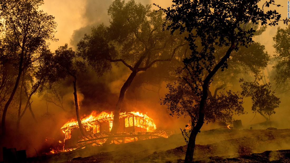 Flames from the Hennessy Fire consume a cabin at the Nichelini Family Winery in Napa County on August 18.