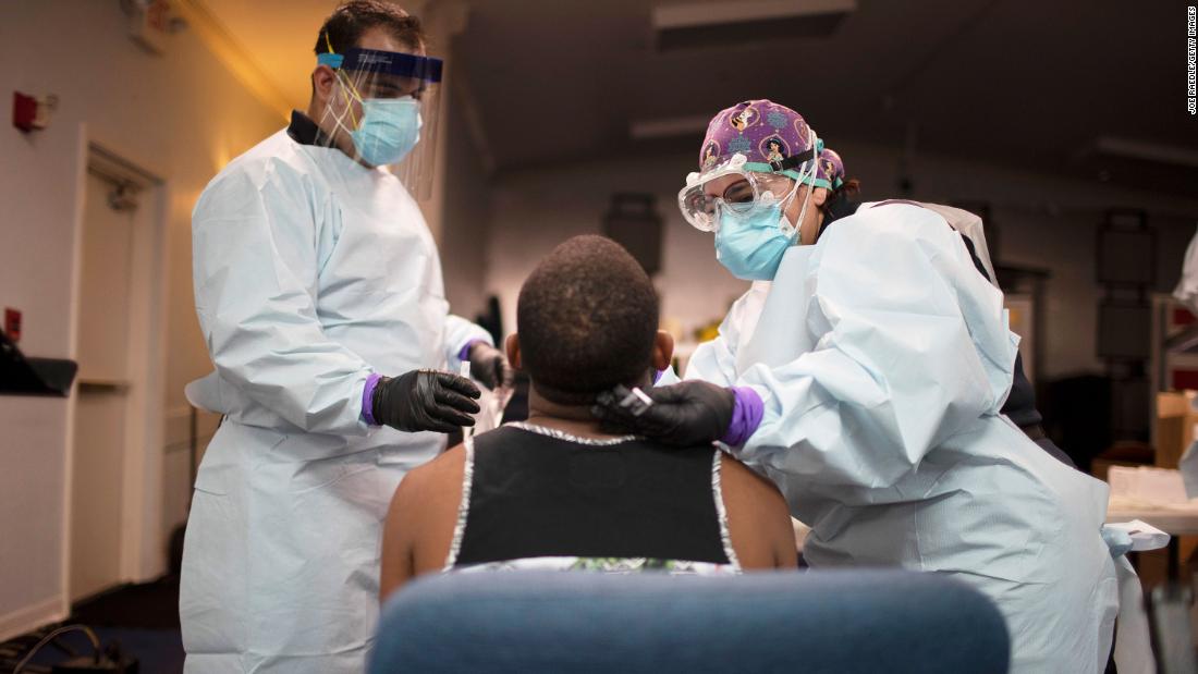 Health care workers use a nasal swab to test a man for Covid-19 at a pop-up testing site on July 22 in Pembroke Park, Florida. 