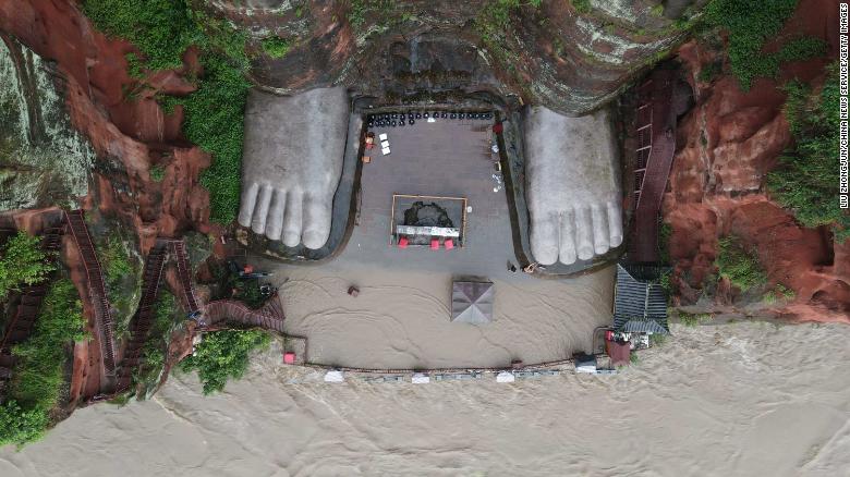 Waters also threatened the Buddha's toes in this photo from August 12.