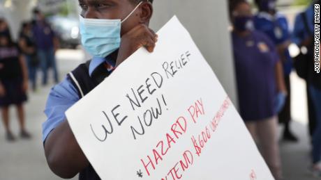 Jean Benjamin joins with unemployed airport workers, the Black Lives Matter Alliance of Broward and other supporters to ask that Delta Airlines contractor, Eulen America, who the demonstrators say received $25 million from the CARES Act, hire back their unemployed Fort Lauderdale-Hollywood International Airport workers on August 13, 2020 in Fort Lauderdale, Florida. They are also asking that U.S. Senators pass the HEROES Act that provides PPE, essential pay and extended unemployment benefits for essential workers. (Photo by Joe Raedle/Getty Images)