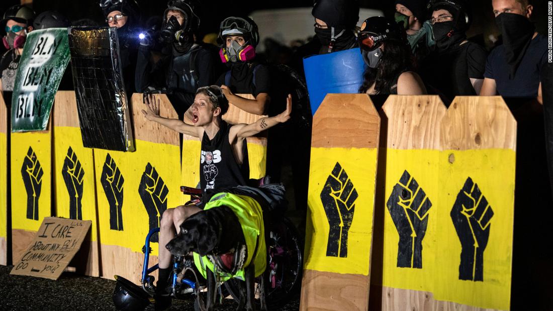 A protester screams at police during a standoff at a Portland precinct on August 15.