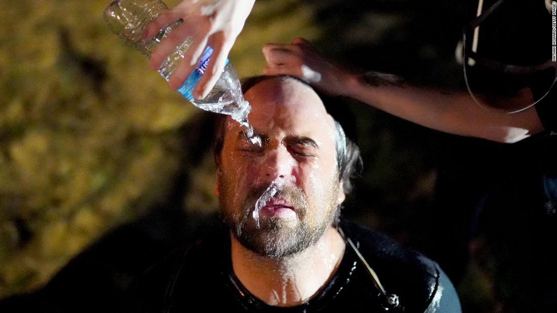 A protester is treated by a street medic after a police officer used pepper spray on him on August 14.