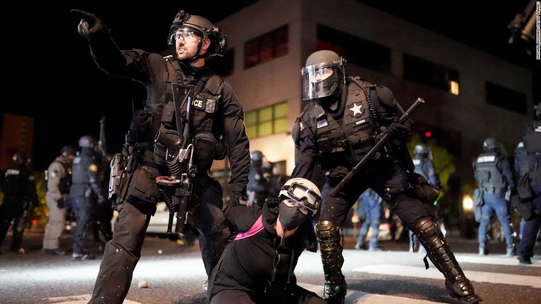 A protester is detained in front of the Portland Police Bureau&#39;s North Precinct on August 11.