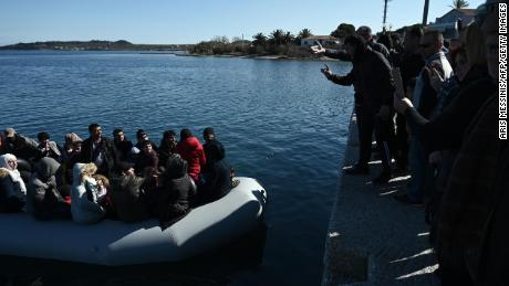 Migrants are seen on an inflatable boat as local residents prevent them from disembarking on the Greek island of Lesbos on March 1.