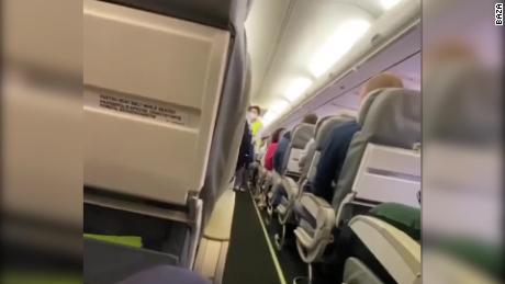 A screenshot taken from a video showing paramedics on a plane about to attend to Navalny after he fell ill in a case of suspected poisoning.