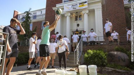 University of Idaho students wear face masks while playing a game outside of Sigma Nu fraternity during fraternity bid day, the final day of the recruitment process, in August.