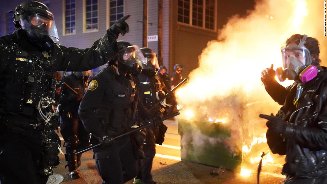 Police officers try to move protesters back on August 21.