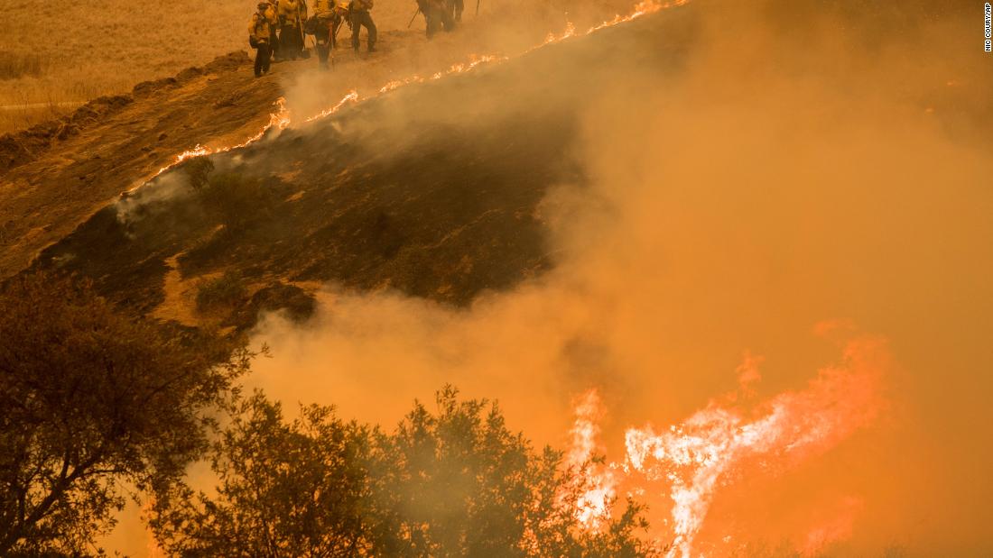 Fire crews maintain a backburn to control the River Fire near the Las Palmas neighborhood in Salinas, California, on August 19, 2020.