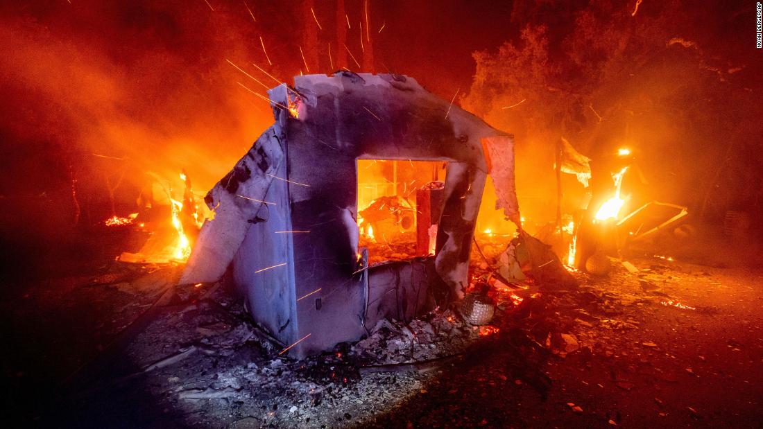 Flames consume a home in Napa County, California, on August 19.