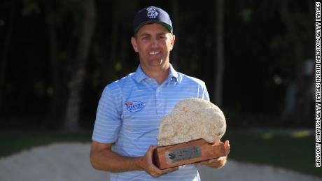 Todd celebrates with the trophy after winning the Mayakoba Golf Classic at El Camaleon Mayakoba Golf Course.
