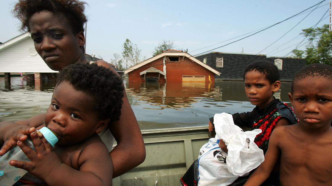 A mother and her children are rescued by boat in New Orleans&#39; Lower Ninth Ward.