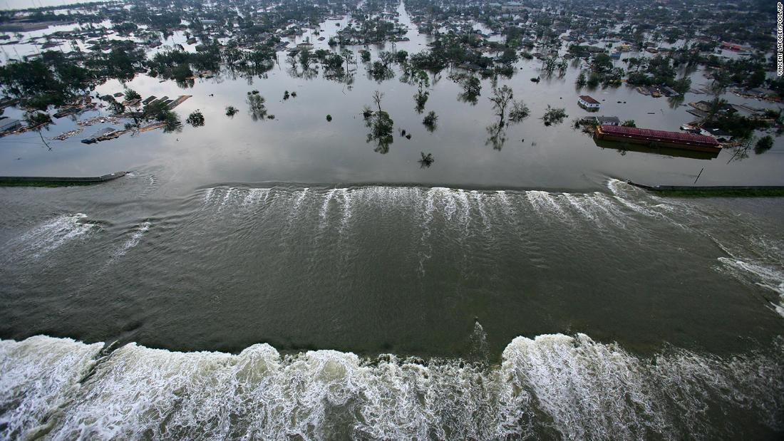 Floodwaters pour through a levee along the Inner Harbor Navigational Canal near downtown New Orleans.