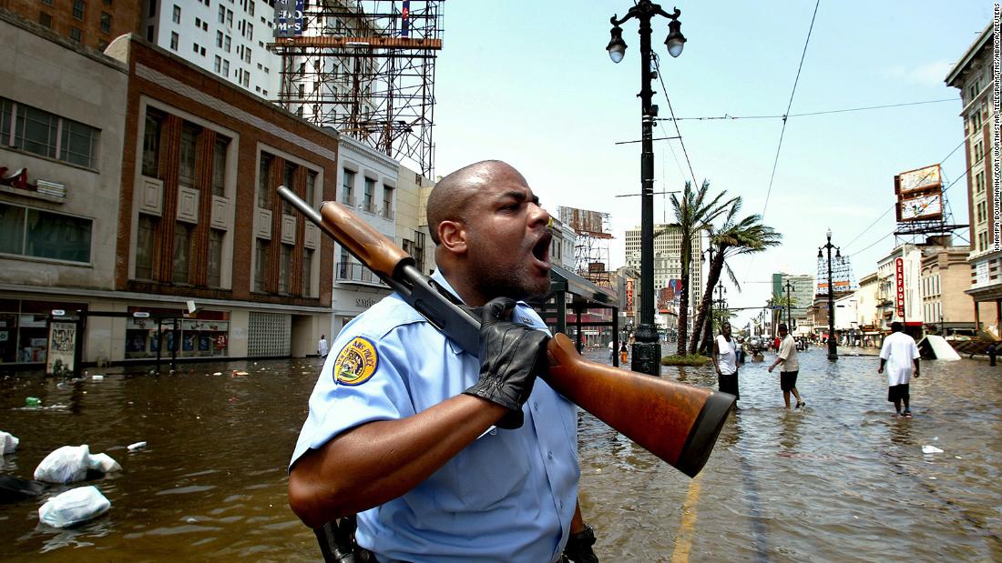 New Orleans police officer Mark Wilson yells at people in stores looters on Canal Street. In Katrina&#39;s aftermath, many questioned whether some people accused of looting were just people scavenging for the supplies they needed to survive.