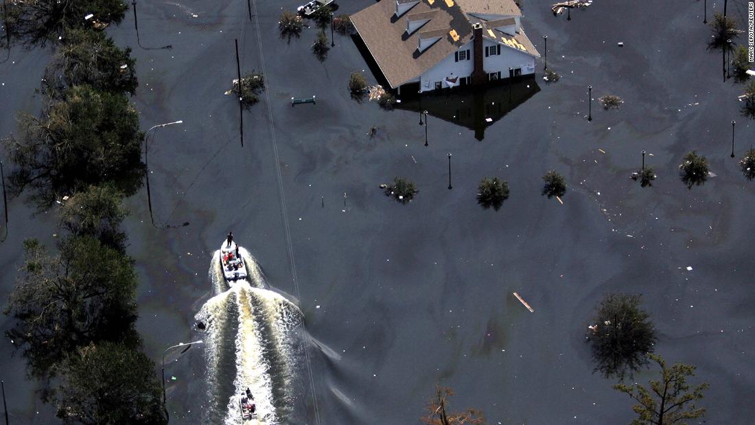 Boats travel down a flooded highway in New Orleans.