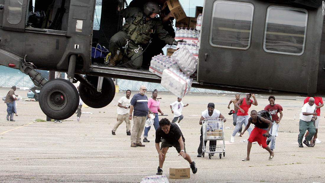 A military helicopter makes a food and water drop near the Convention Center in New Orleans.