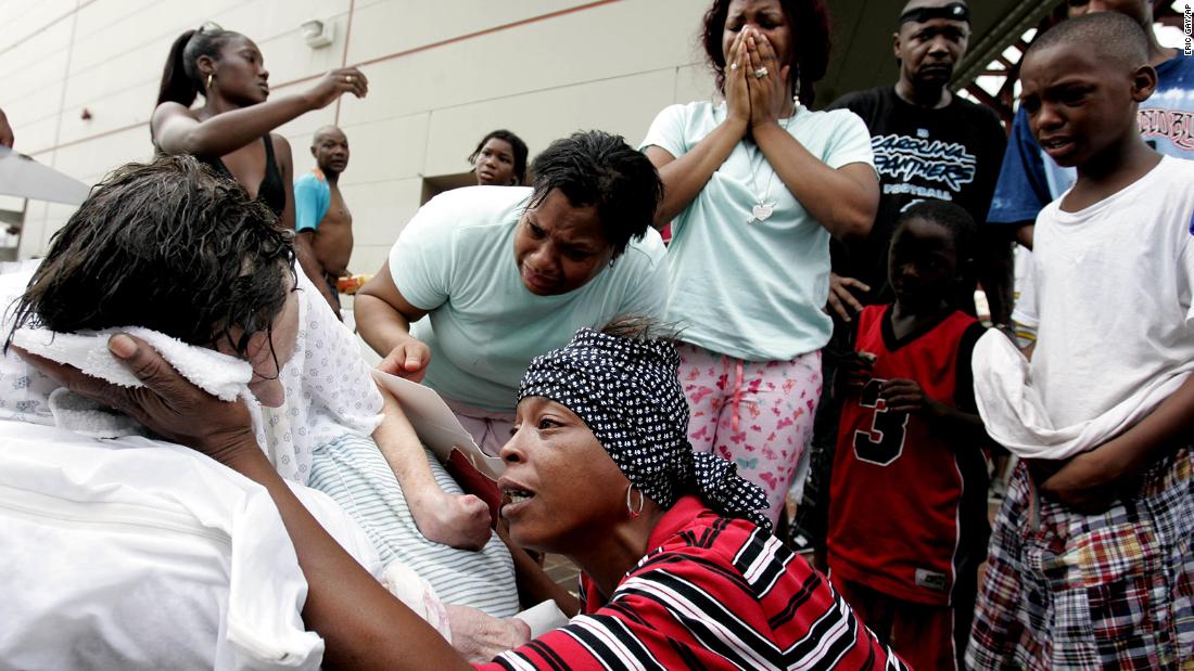 Terri Jones tries to cool Dorthy Divic, an 89-year-old who was overheated and exhausted at the Convention Center in New Orleans.