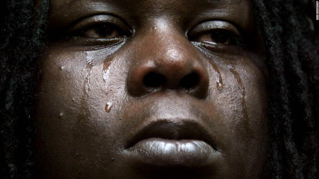 Leonard Thomas cries after a SWAT team burst into the flooded New Orleans home he and his family were living in. Neighbors had reported that they were squatting in the house in the wake of Hurricane Katrina, but the authorities left after his family proved they owned the house.