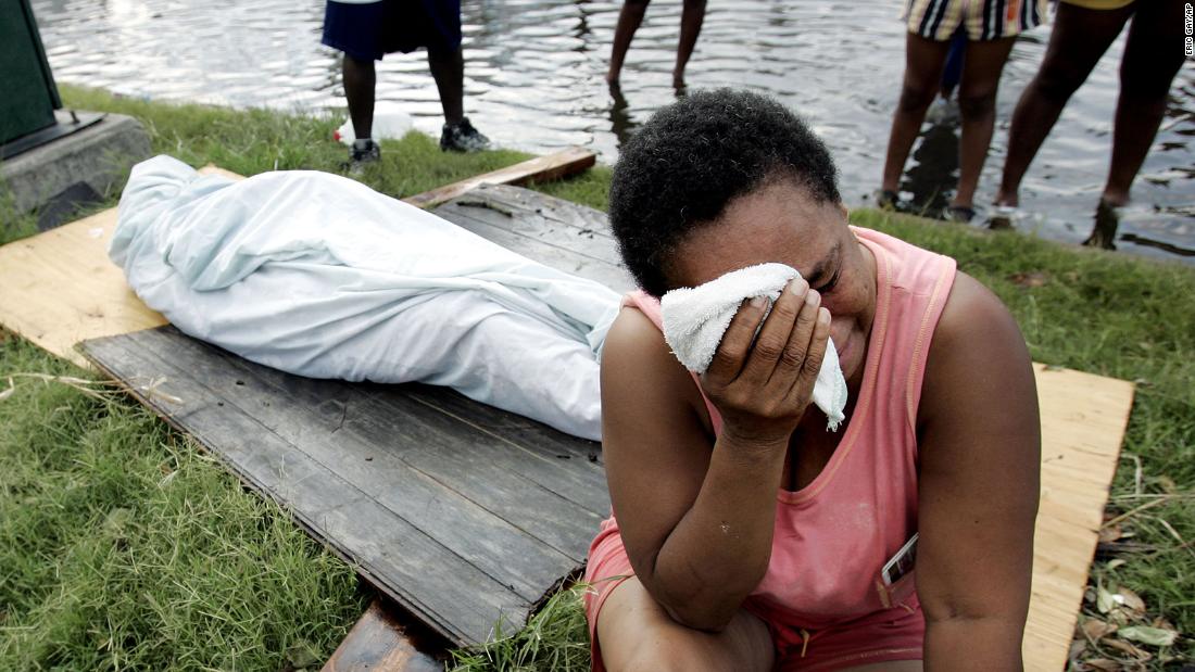 Evelyn Turner cries alongside the body of her longtime companion, Xavier Bowie, after he died in New Orleans. Turner and Bowie decided to ride out Hurricane Katrina when they could not find a way to leave the city. Bowie, who had lung cancer, died when he ran out of oxygen. He was 57.