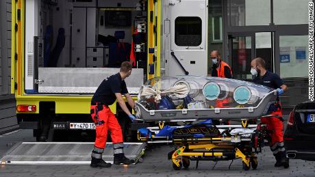 German army medics transport a stretcher carrying Alexey Navalny at Berlin&#39;s Charite hospital.