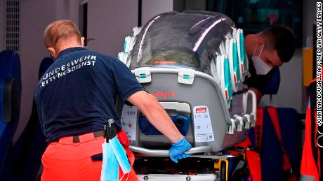 German army emergency personnel load the stretcher that was used to transport Russian opposition figure Alexei Navalny into an ambulance on August 22, 2020 at Berlin's Charite hospital.