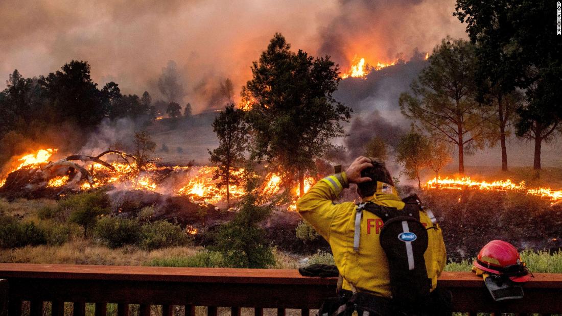 A firefighter watches the LNU Lightning Complex fires spread through the Berryessa Estates neighborhood in Napa County on August 21, 2020.