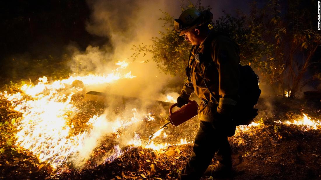 A firefighter monitors the advance of a fire in Boulder Creek on August 21.
