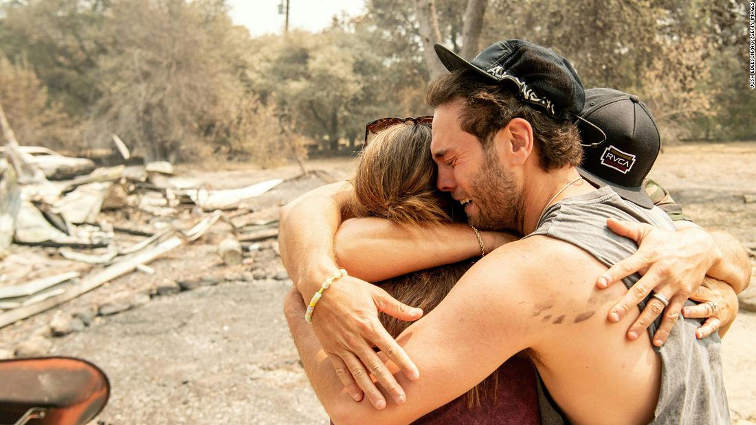 Austin Giannuzzi cries while embracing relatives at the burned remains of their Vacaville home on August 23, 2020.