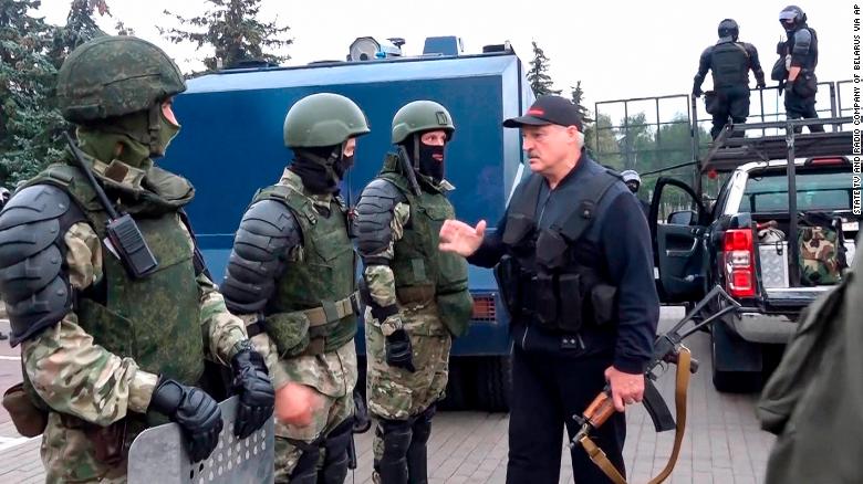 Lukashenko greets riot police near the Palace of Independence in Minsk on Sunday, in an image shown on state TV.