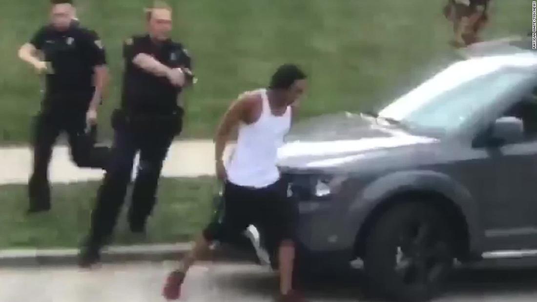 In this screengrab taken from video, police follow Jacob Blake as he walks to the driver&#39;s side door of an SUV on August 23. He was shot a few moments later.