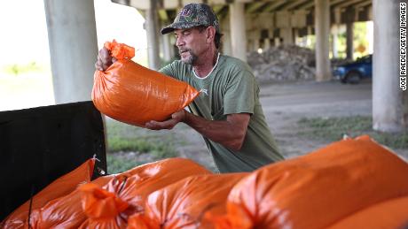 Ken Allen fills sandbags Monday as he prepares for the arrival of storms Marco and Laura in Morgan City, Louisiana.